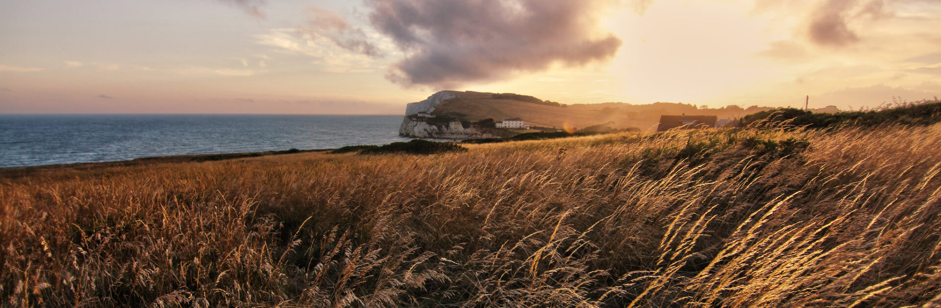 Winter view of Freshwater Bay on the Isle of Wight with cliffs, calm sea, and pebble beach under soft seasonal light.