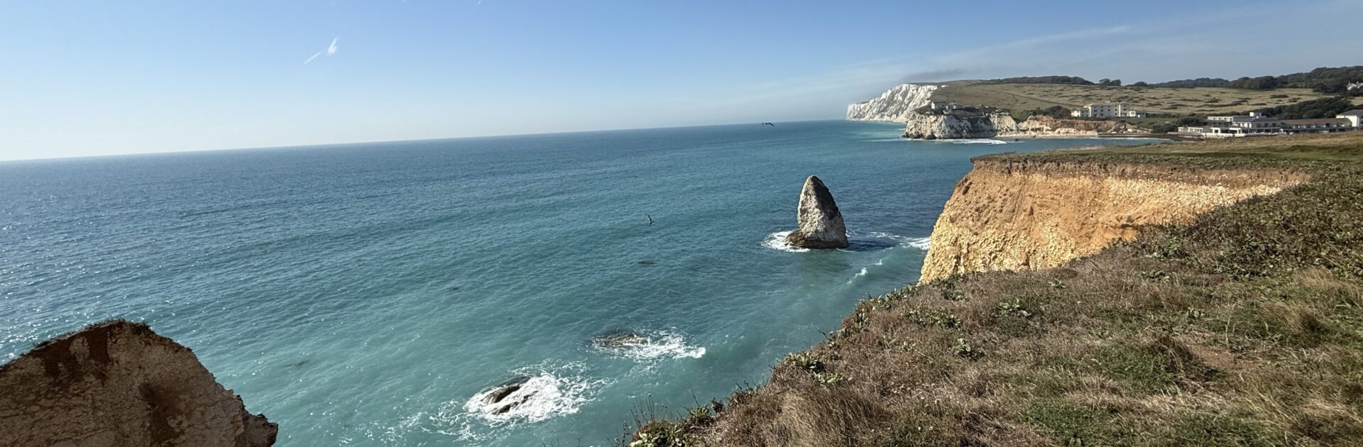 Peaceful morning tide and white chalk cliffs at Freshwater Bay, offering pure coastal serenity.