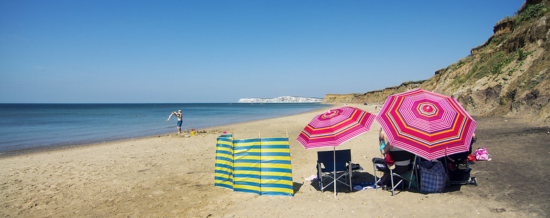 Family bonding on a coastal beach, highlighting the 'Gift of Time' with a Mother's Day holiday at The Island Holiday Company.