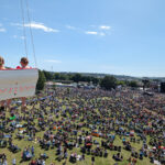A vibrant crowd enjoying live music at the Isle of Wight Festival, perfect for guests staying in local Isle of Wight festival accommodation.