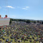 A vibrant crowd enjoying live music at the Isle of Wight Festival, perfect for guests staying in local Isle of Wight festival accommodation.
