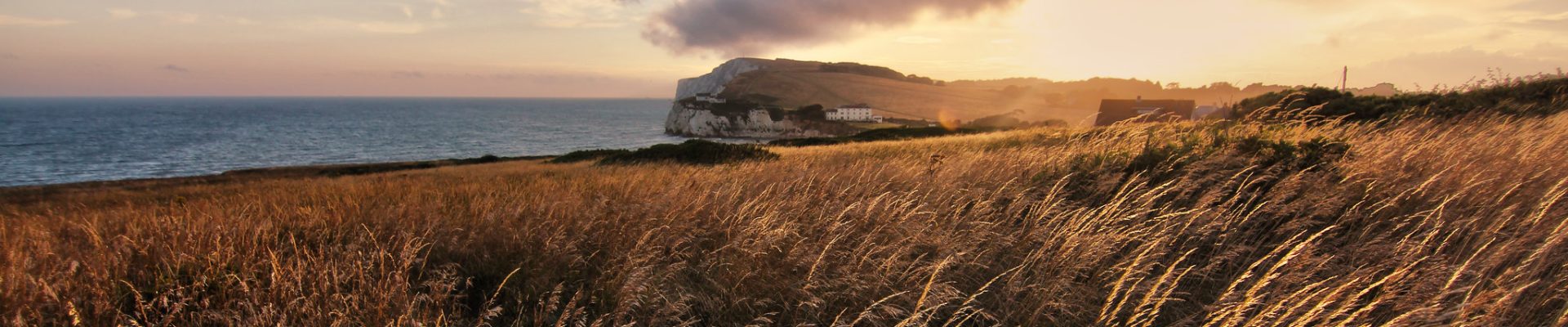 Winter view of Freshwater Bay on the Isle of Wight with cliffs, calm sea, and pebble beach under soft seasonal light.