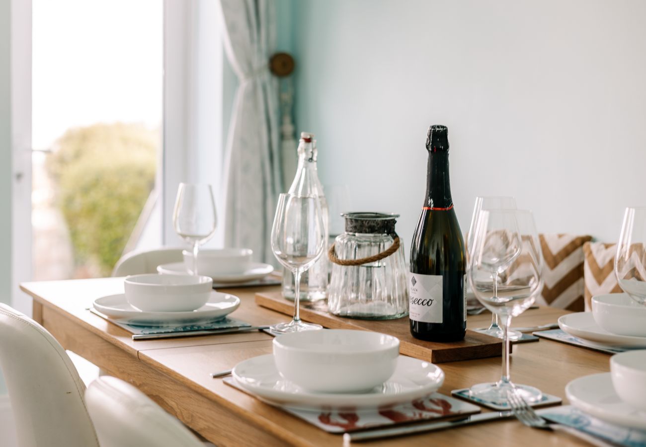 Dining table in Cowes Garden Apartment with modern chairs and natural light