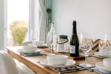 Dining table in Cowes Garden Apartment with modern chairs and natural light