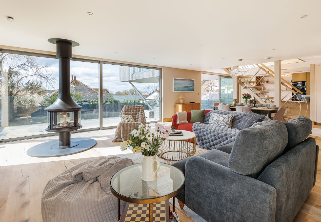 Spacious open-plan living, dining, and kitchen area at Rena’s Retreat with natural light, modern furnishings, and indoor-outdoor access to terrace and