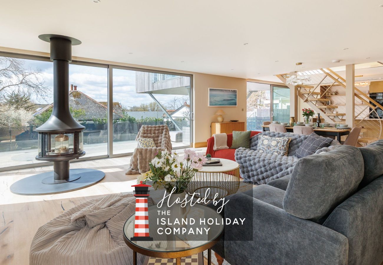 Spacious open-plan living, dining, and kitchen area at Rena’s Retreat with natural light, modern furnishings, and indoor-outdoor access to terrace and