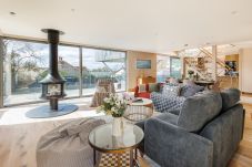 Spacious open-plan living, dining, and kitchen area at Rena’s Retreat with natural light, modern furnishings, and indoor-outdoor access to terrace and