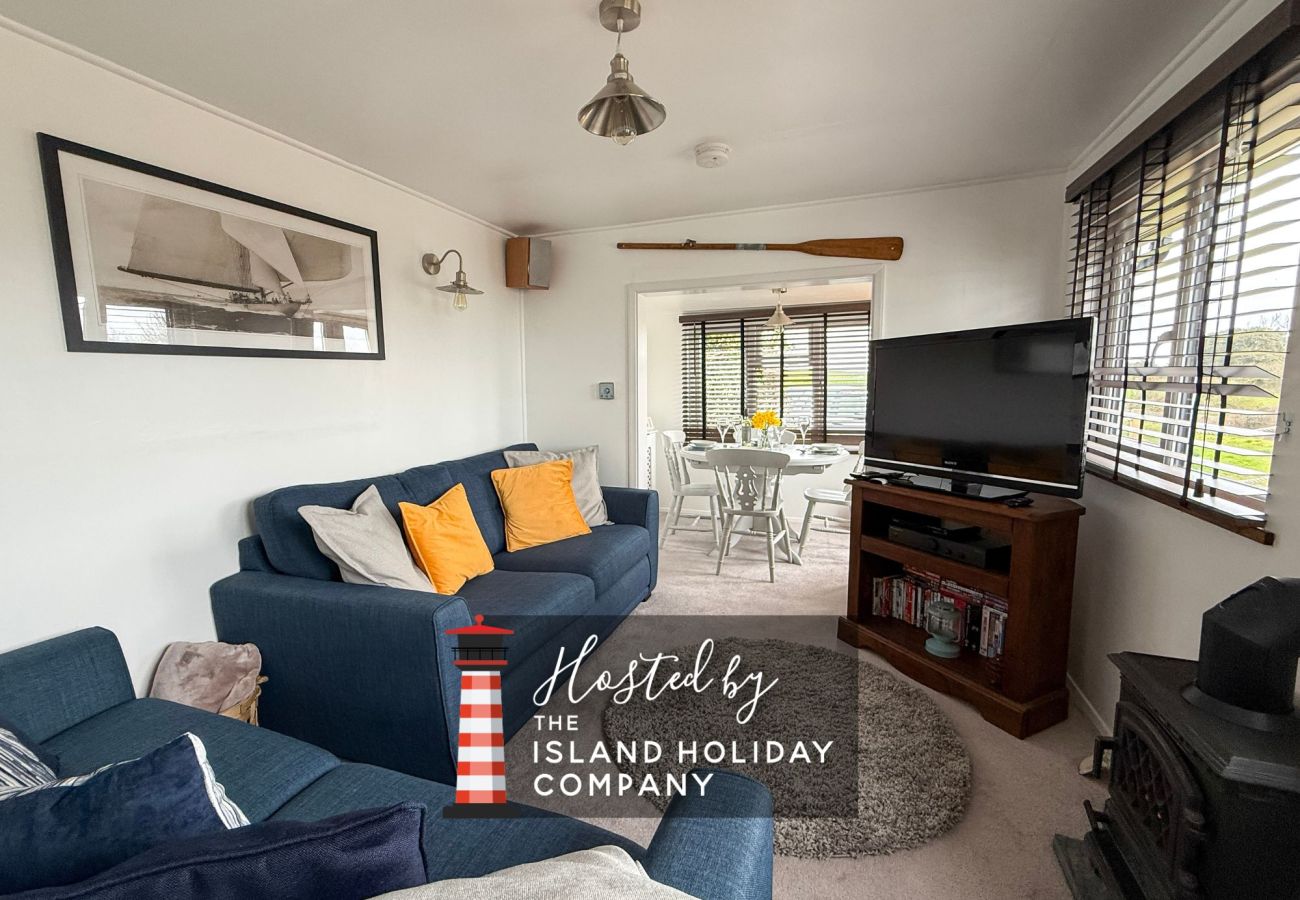 Spacious open-plan living and dining area at Red Cedars with modern furnishings, natural light, and coastal-inspired décor, perfect for families and g