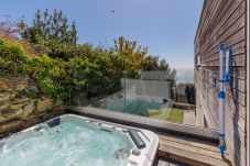 Private outdoor hot tub overlooking the sea and coastline