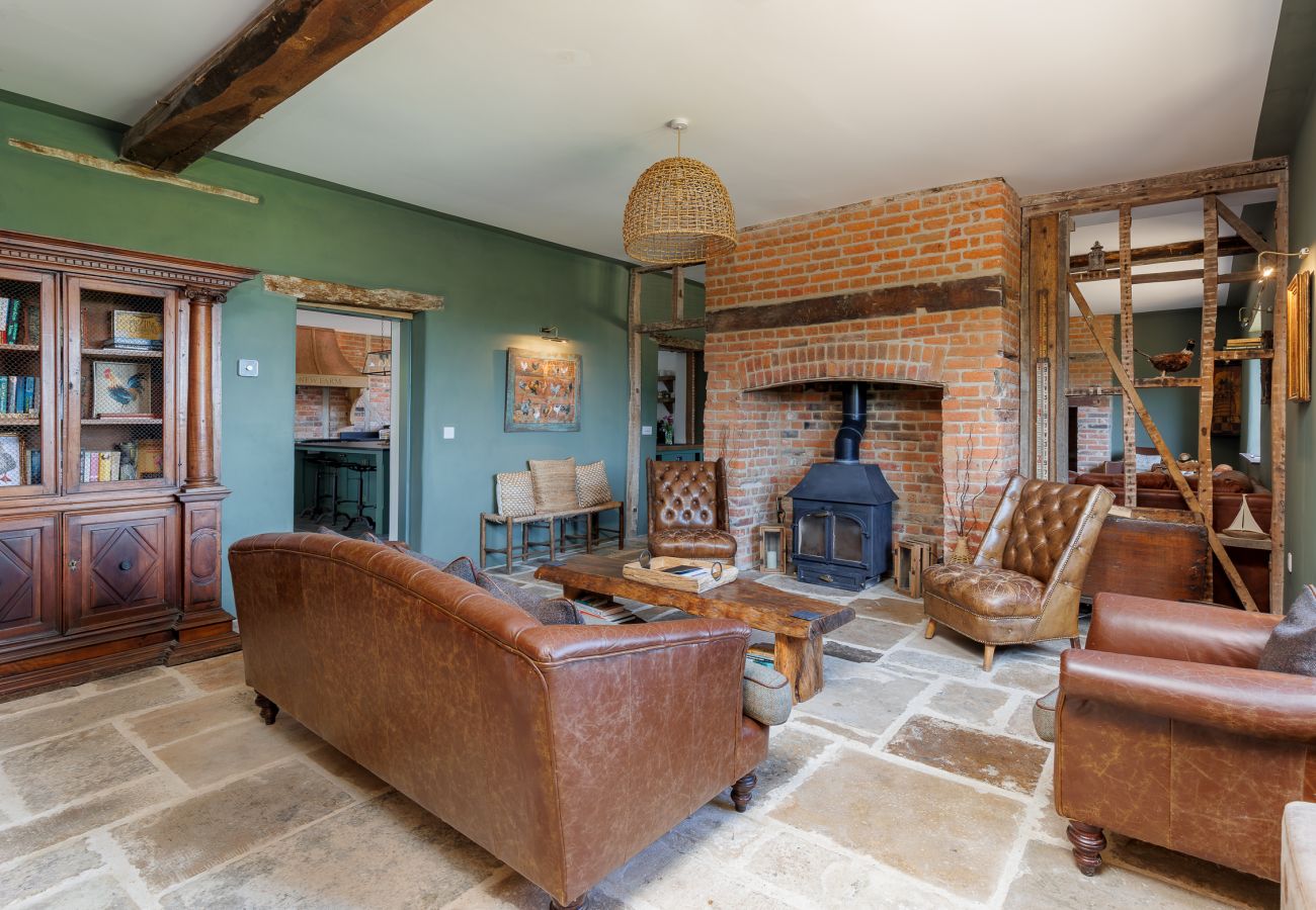 Spacious living area with log burner at The Farmhouse at Nunwell holiday home on the Isle of Wight