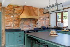Large fully equipped kitchen with breakfast bar at The Farmhouse at Nunwell holiday home on the Isle of Wight