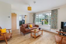 Living room with views over the garden in modern holiday home
