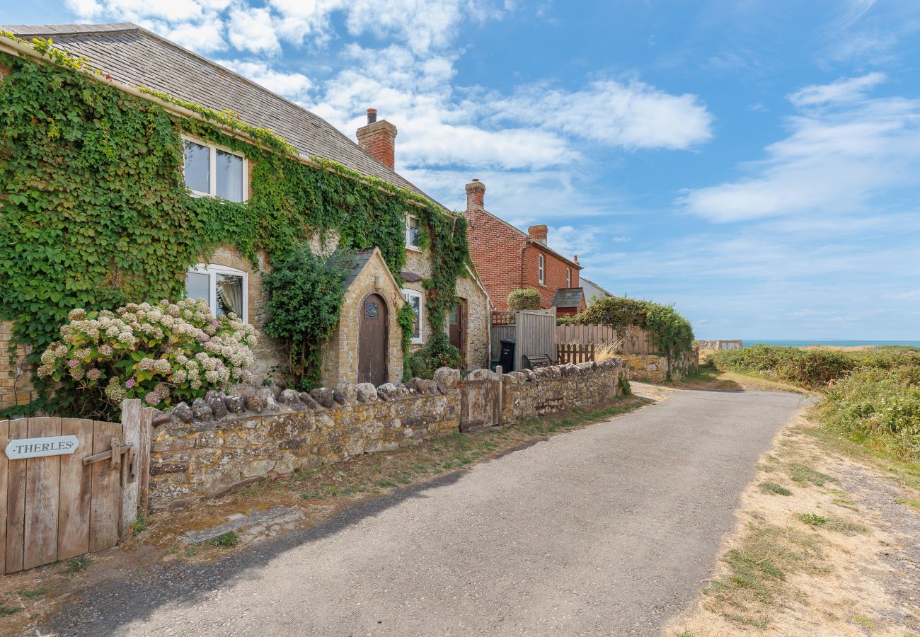 Exterior of Moon Chine Cottage with the sea visible in the background on the Isle of Wight.