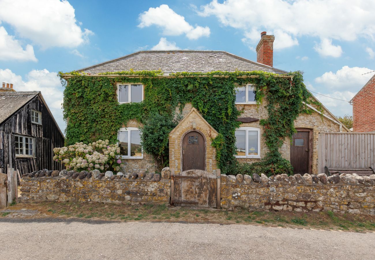 Front exterior of Moon Chine Cottage surrounded by peaceful countryside on the Isle of Wight.