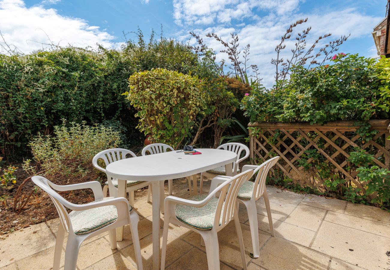 Private patio area with outdoor seating beside Moon Chine Cottage on the Isle of Wight.