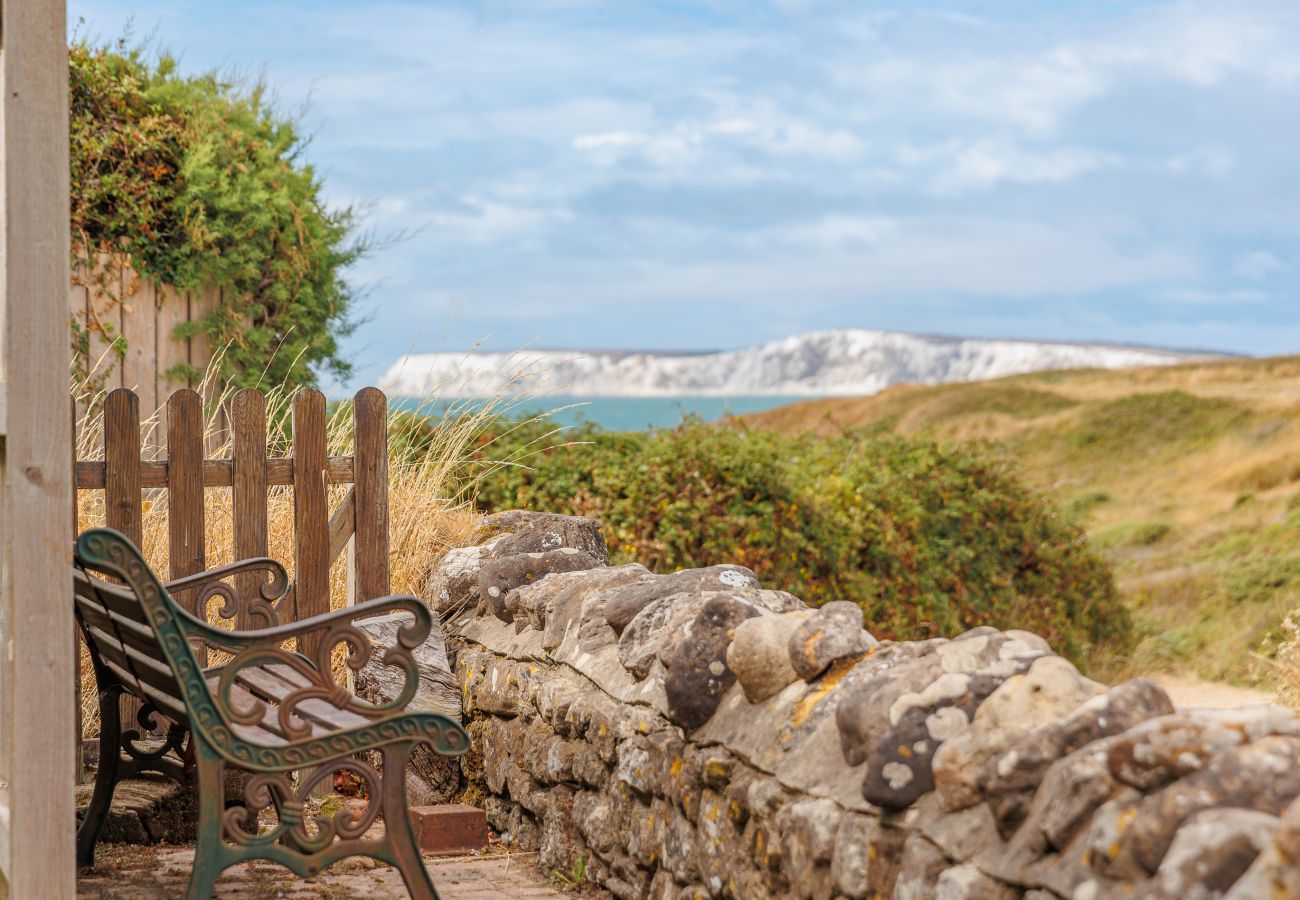 Coastal and countryside views from the bench at Moon Chine Cottage, overlooking the sea and white cliffs.