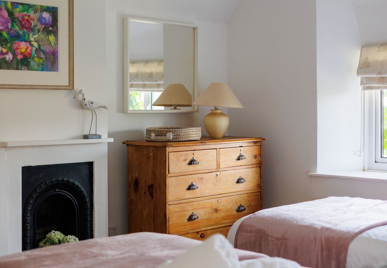 Characterful twin bedroom with traditional features at Moon Chine Cottage on the Isle of Wight.