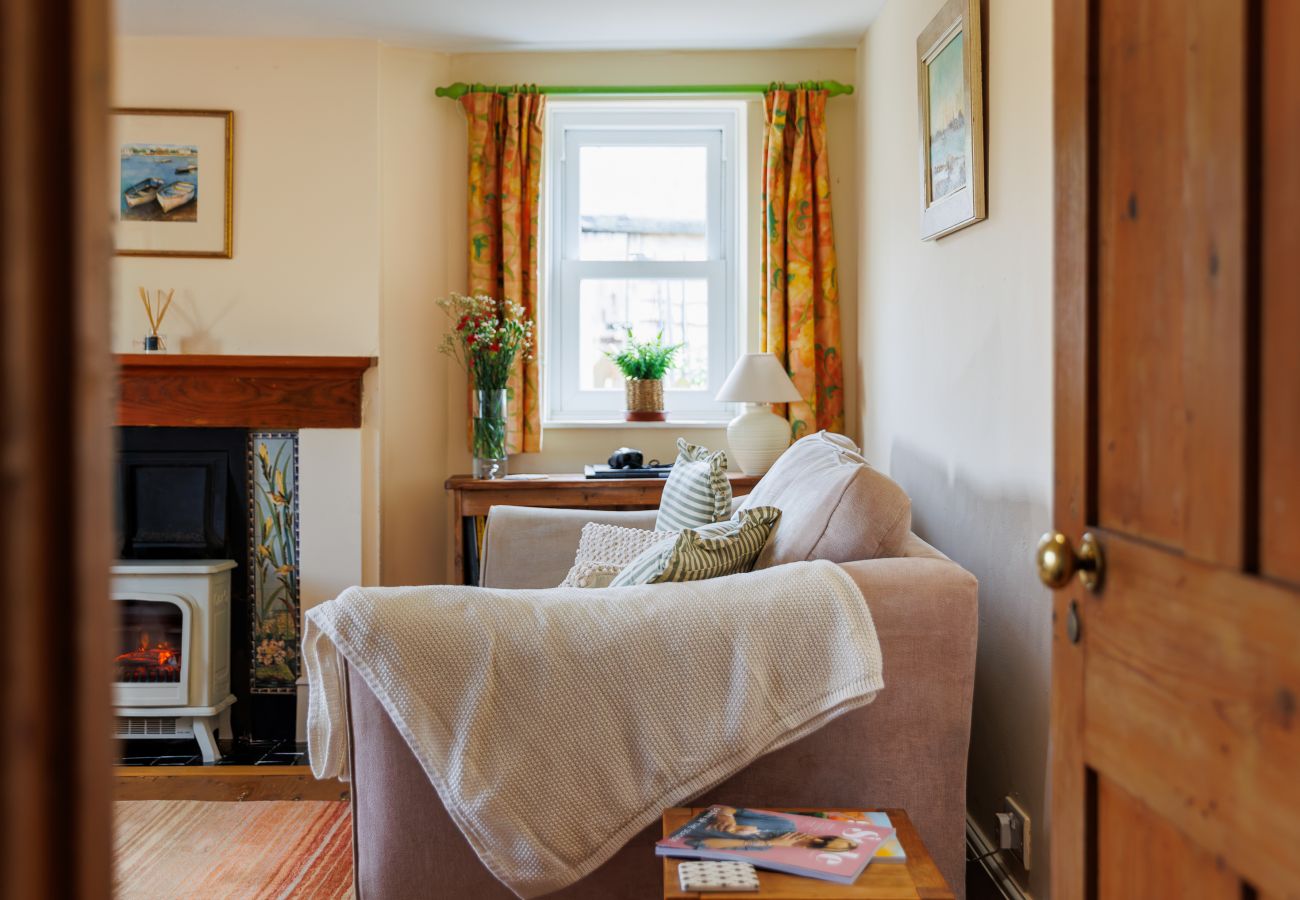 Cosy living room with an electric log effect fire at Moon Chine Cottage on the Isle of Wight.