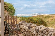 Coastal and countryside views from the bench at Moon Chine Cottage, overlooking the sea and white cliffs.