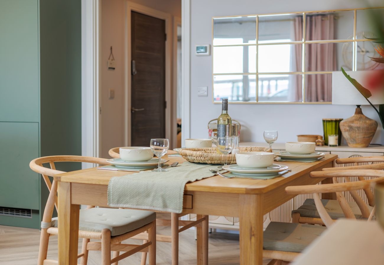 Dining table and chairs in Hummingbird’s open-plan living and dining area on Sandown seafront.