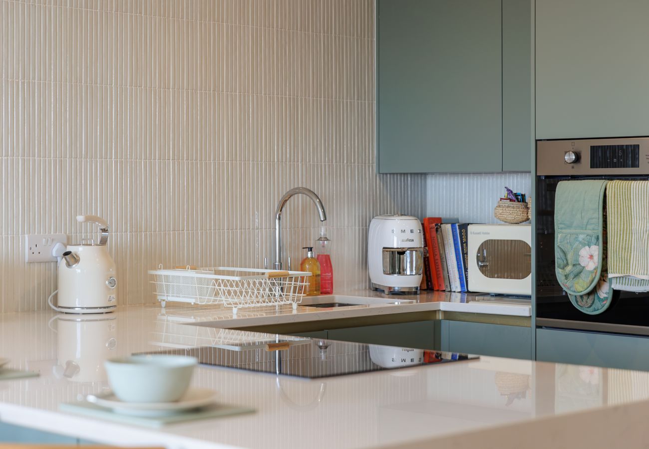 Fully equipped modern kitchen at Hummingbird, a two-bedroom ground-floor apartment on Sandown seafront.