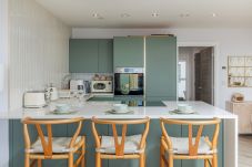 Modern kitchen and breakfast bar at Hummingbird, a two-bedroom ground-floor apartment on Sandown seafront.